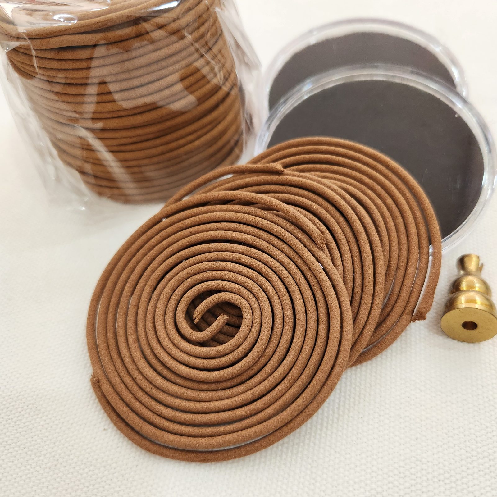 Golden Lotus incense coil burning with accessories