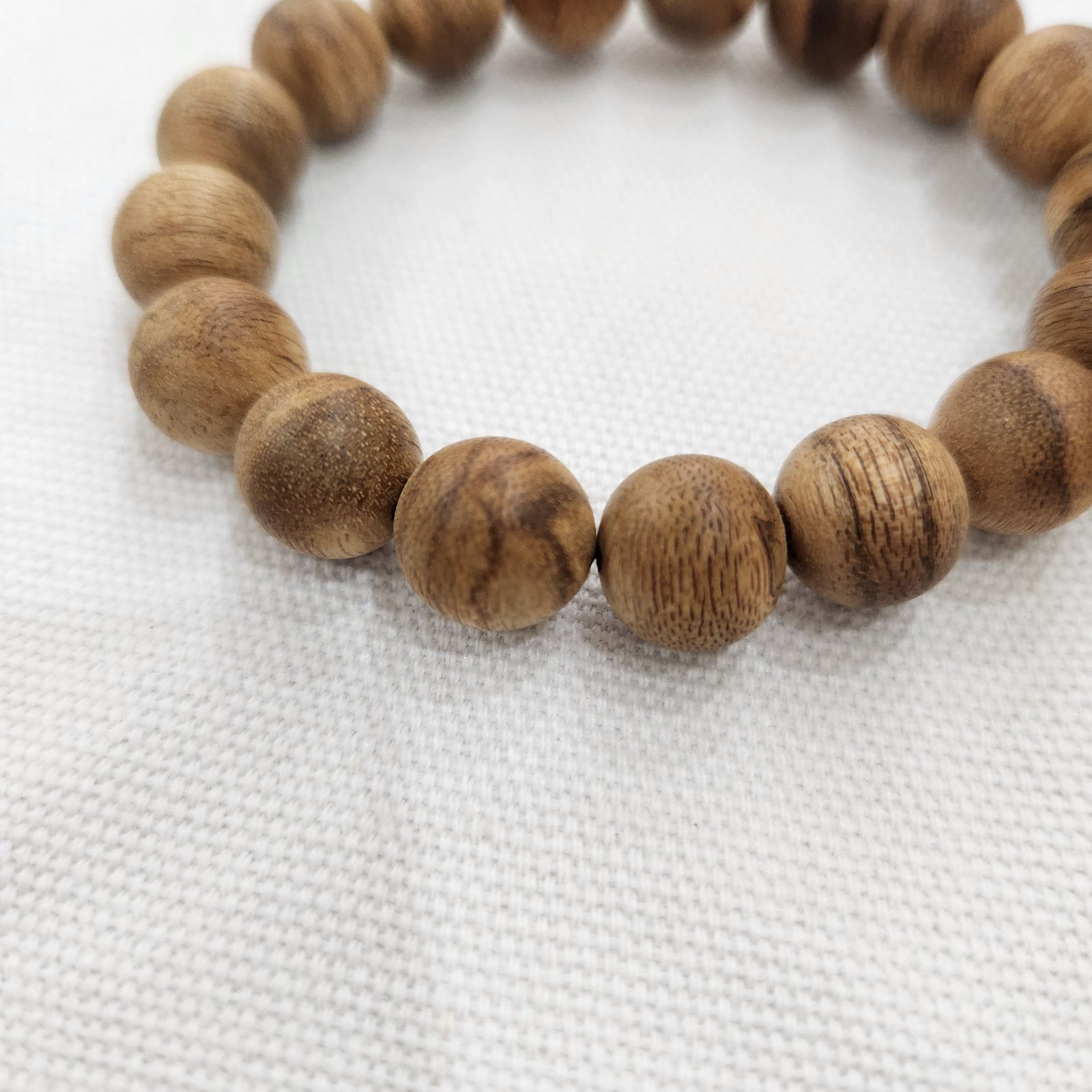 Wood grain and emerging resin character on the bracelet beads